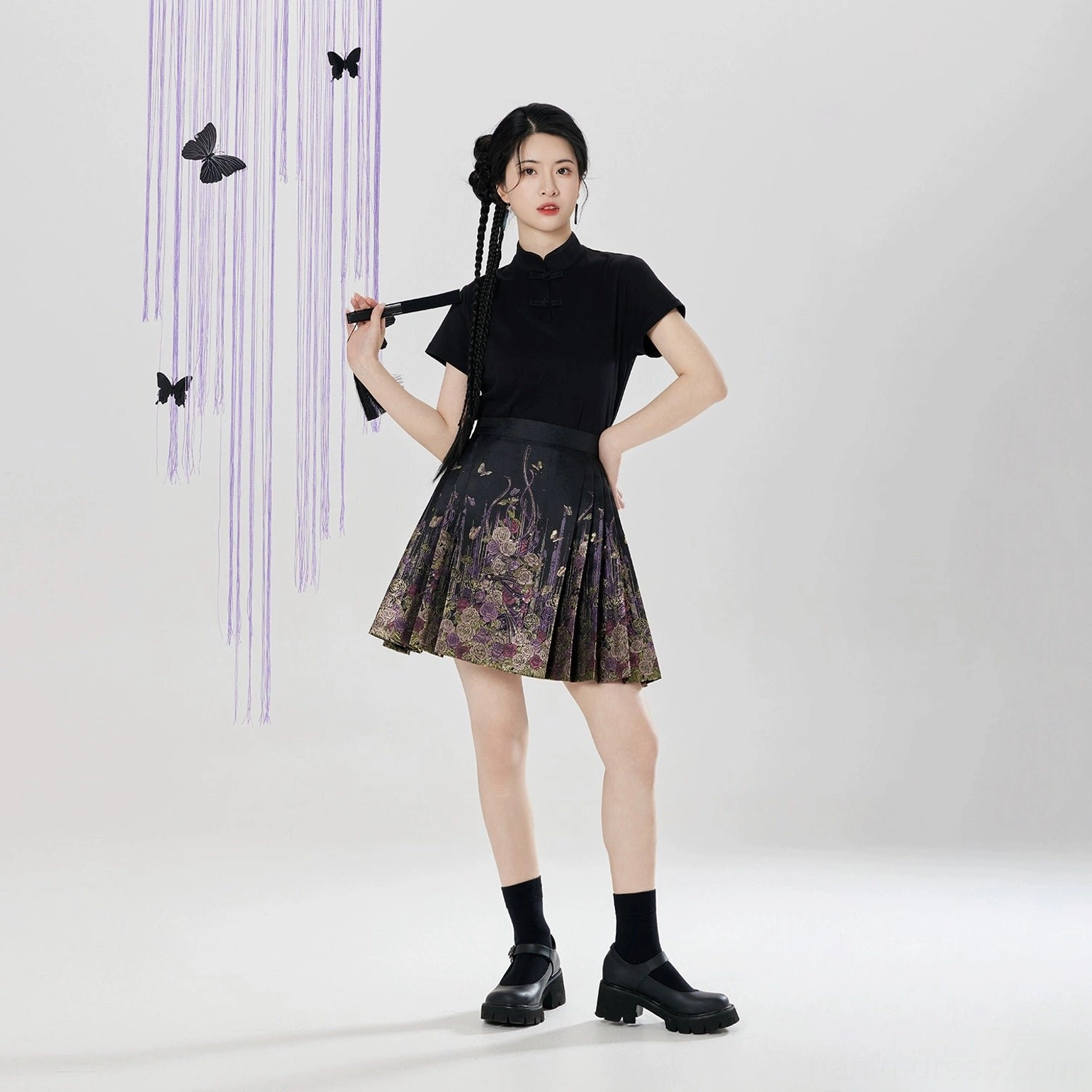 Low angle full outfit styling image featuring black floral brocade mini mamian skirt and Chinese inspired blouse