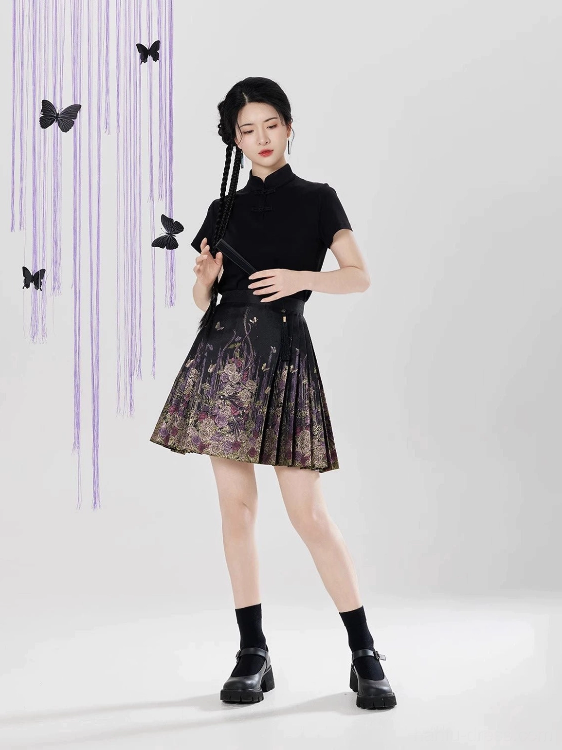 Three-quarter view of black Ming Dynasty Hanfu inspired mini mamian skirt with floral brocade pattern and pleats
