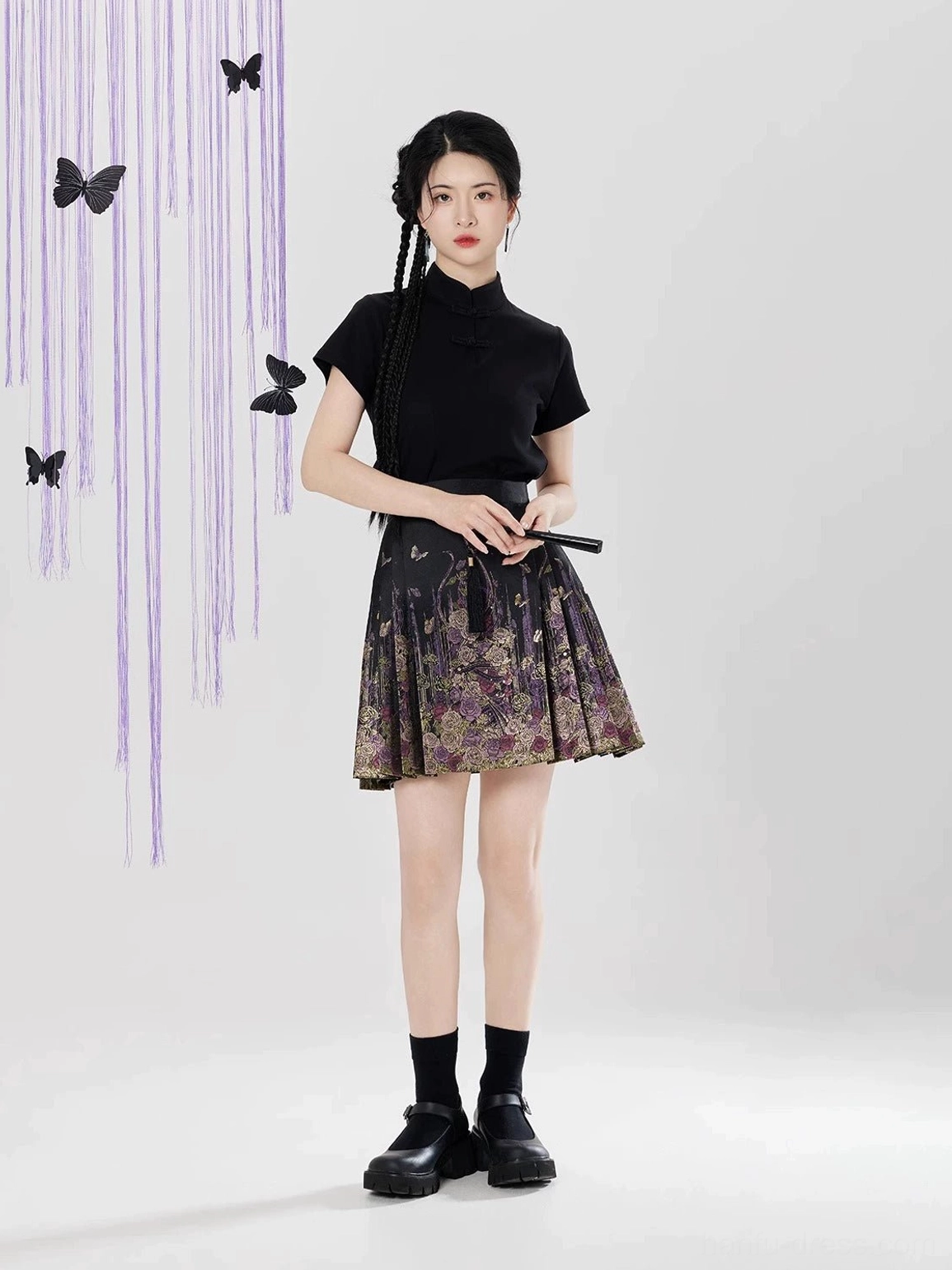 Front view of black floral brocade mini mamian skirt styled as a modern Chinese Hanfu fashion look