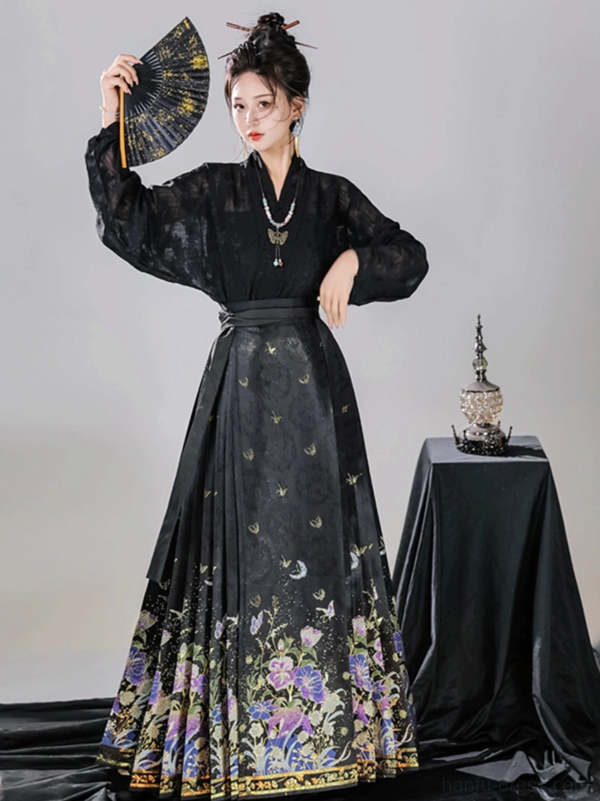 Black Ming Dynasty style floral mamianqun horse face skirt styled with sheer black Hanfu top and folding fan