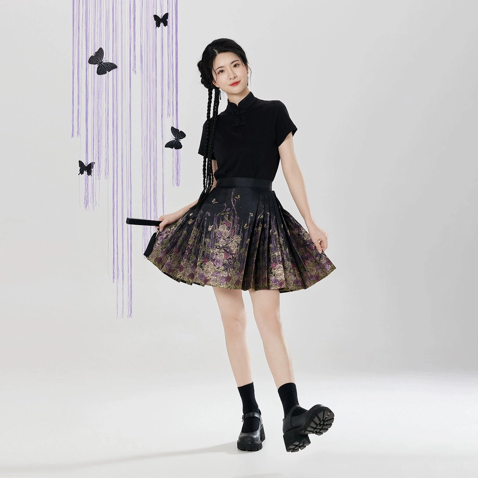 Side view of black floral mini mamian skirt showing flowing pleats and short Ming inspired Hanfu silhouette