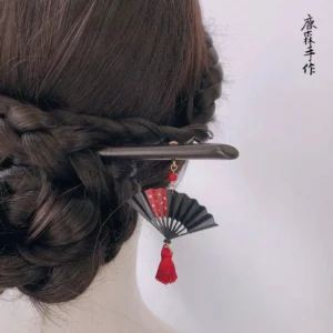 Black folding fan red tassel Chinese hair stick worn in a braided updo for Hanfu hairstyle styling