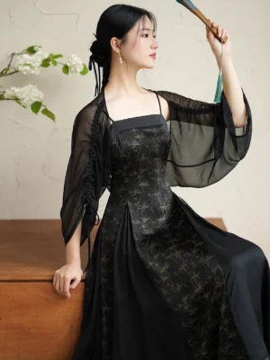 Black and gold bamboo modern Hanfu dress with sheer batwing cardigan, square neckline, floor-length silhouette, and folding fan styling