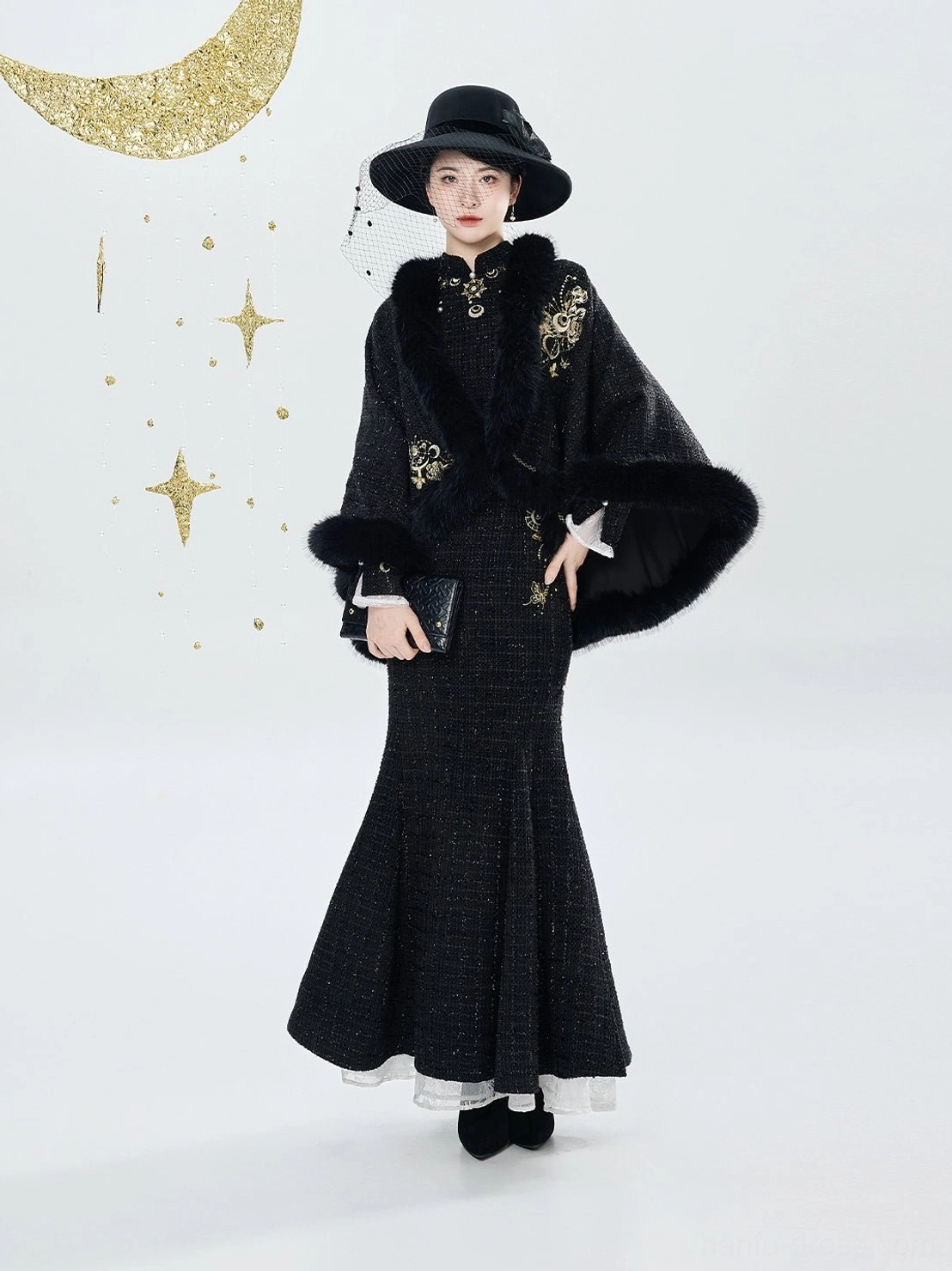 Three-quarter view of black modern hanfu qipao and embroidered plush-trim cloak formal outfit with gold details
