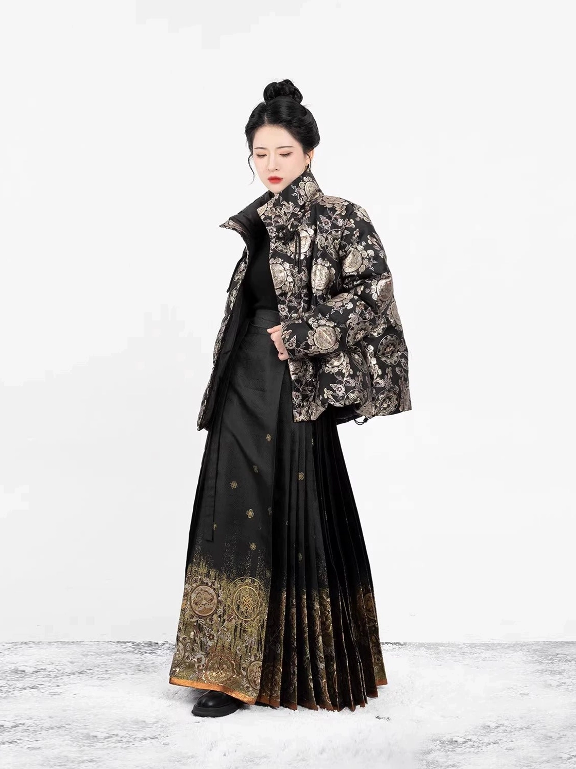 Three-quarter view of a black and gold floral jacquard modern Hanfu puffer jacket with cropped boxy fit and Chinese-inspired styling
