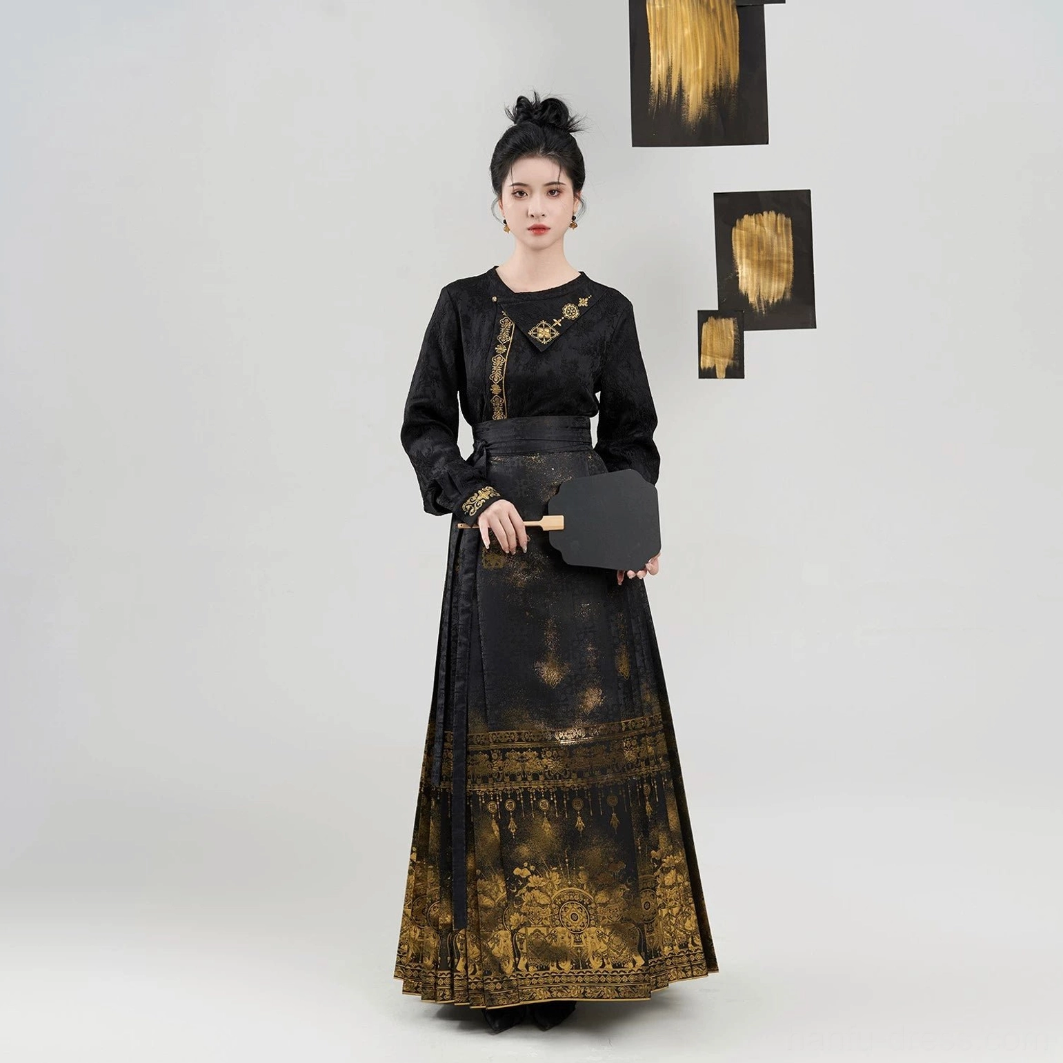 Full front view of black and gold Ming Dynasty Hanfu mamianqun two-piece set with a textured long-sleeve top and flowing pleated horse-face skirt