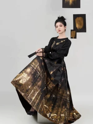 Black and gold Ming Dynasty Hanfu mamianqun outfit shown from a low three-quarter side view with the flowing pleated horse-face skirt lifted to reveal ornate gilded hem patterns
