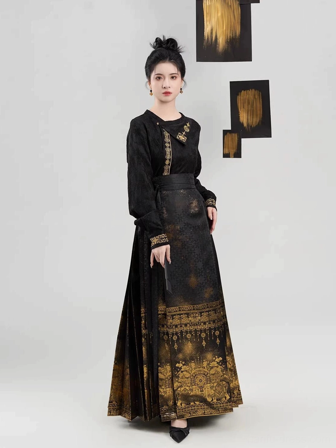 Side view of black and gold Ming Dynasty Hanfu two-piece outfit showing the tailored long sleeves, embroidered-look cuffs, high waistband, and pleated mamianqun silhouette