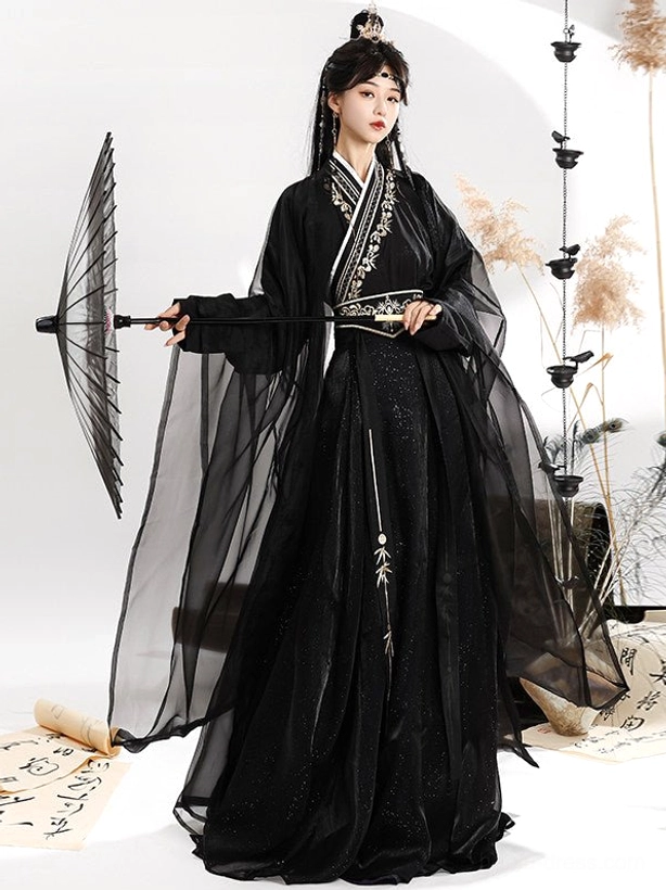 Three-quarter view of a complete black and gold Wei Jin Dynasty Hanfu with sheer outer robe, embroidered skirt, oil-paper umbrella, and sword