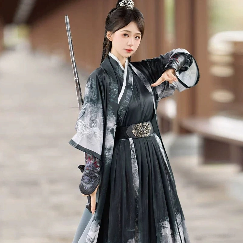 Close three-quarter view of a female swordswoman wearing a black gradient ink-wash Wei Jin Dynasty Hanfu with ornate metal waist belt, embroidered bracers, and a sword over her shoulder