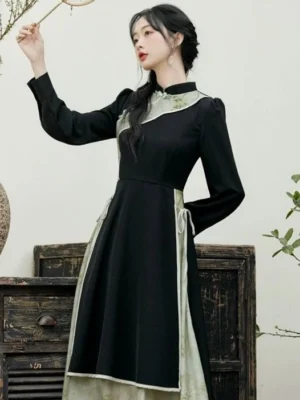 Black and ink green modern Hanfu cheongsam inspired dress with puff sleeves and drawstring waist front three quarter view