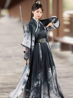 Black ink-wash Wei Jin Dynasty Qiyao Ruqun Hanfu set on a female swordswoman model, featuring a cross-collar robe, botanical patterned flowing skirt, ornate metal waist belt, and embroidered bracers in a traditional courtyard