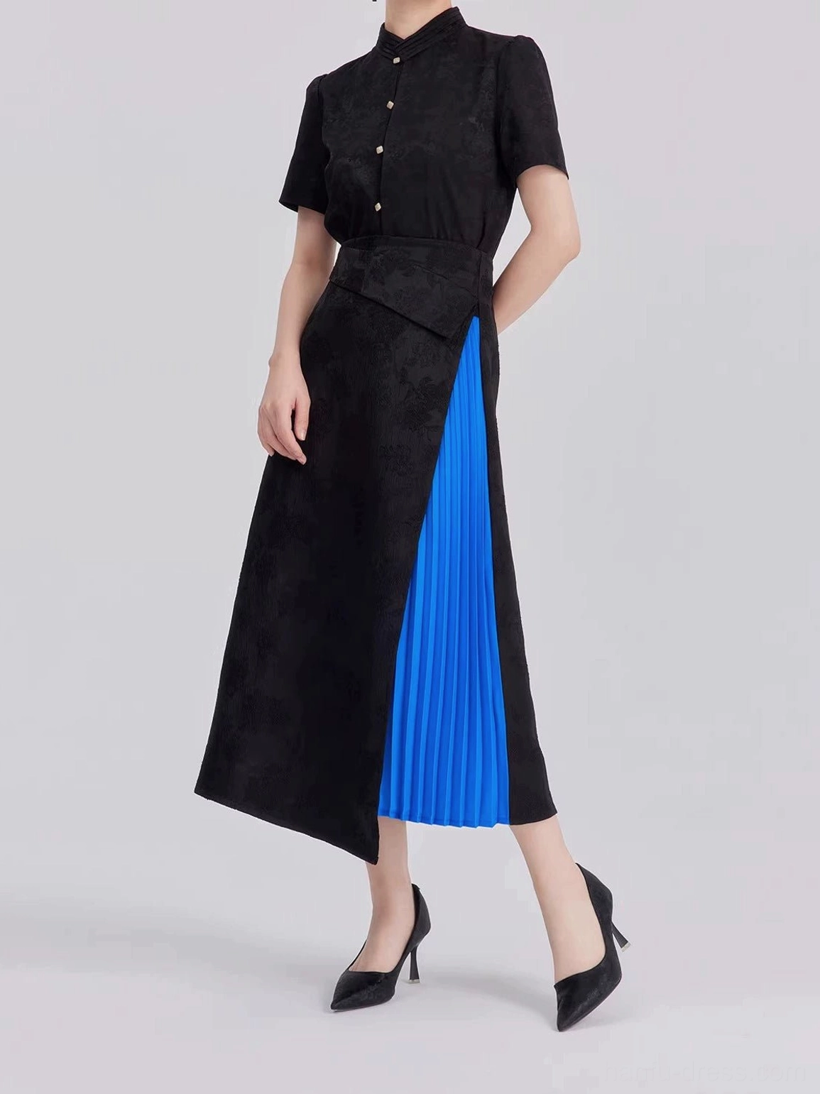 Low-angle view of black floral jacquard modern Hanfu outfit showing stand collar cropped top and flowing asymmetrical skirt hem