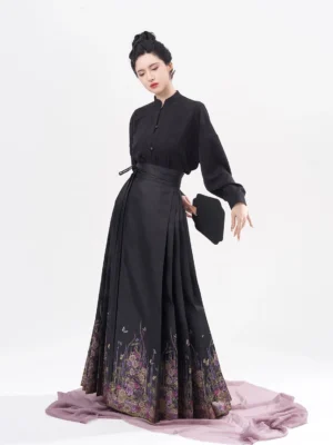 Oblique view of black long sleeve Chinese blouse with frog buttons and traditional floral mamian skirt outfit