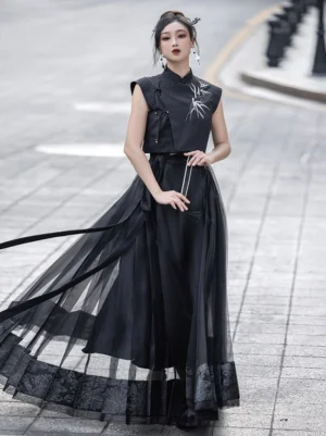Three-quarter view of black Mandarin collar Chinese crop top with bamboo embroidery and layered tulle skirt styling
