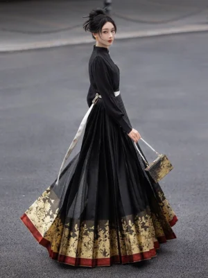 Side view of a model wearing a black Ming Dynasty Hanfu mamianqun skirt with pleated fabric, gilded peony floral hem, red trim, white waist sash, black top, and vintage handbag outdoors