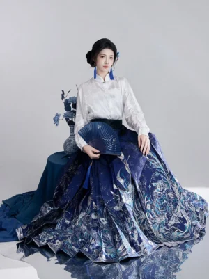 Black Ming-inspired Hanfu set with stand-collar long sleeve top and blue phoenix floral mamian skirt in studio