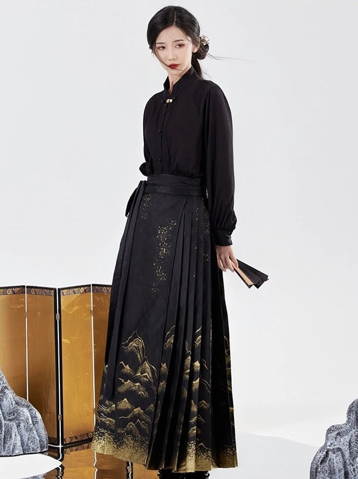 Side view of black Ming style Hanfu with stand collar blouse, high waisted gold landscape mamianqun horse face skirt and folding fan