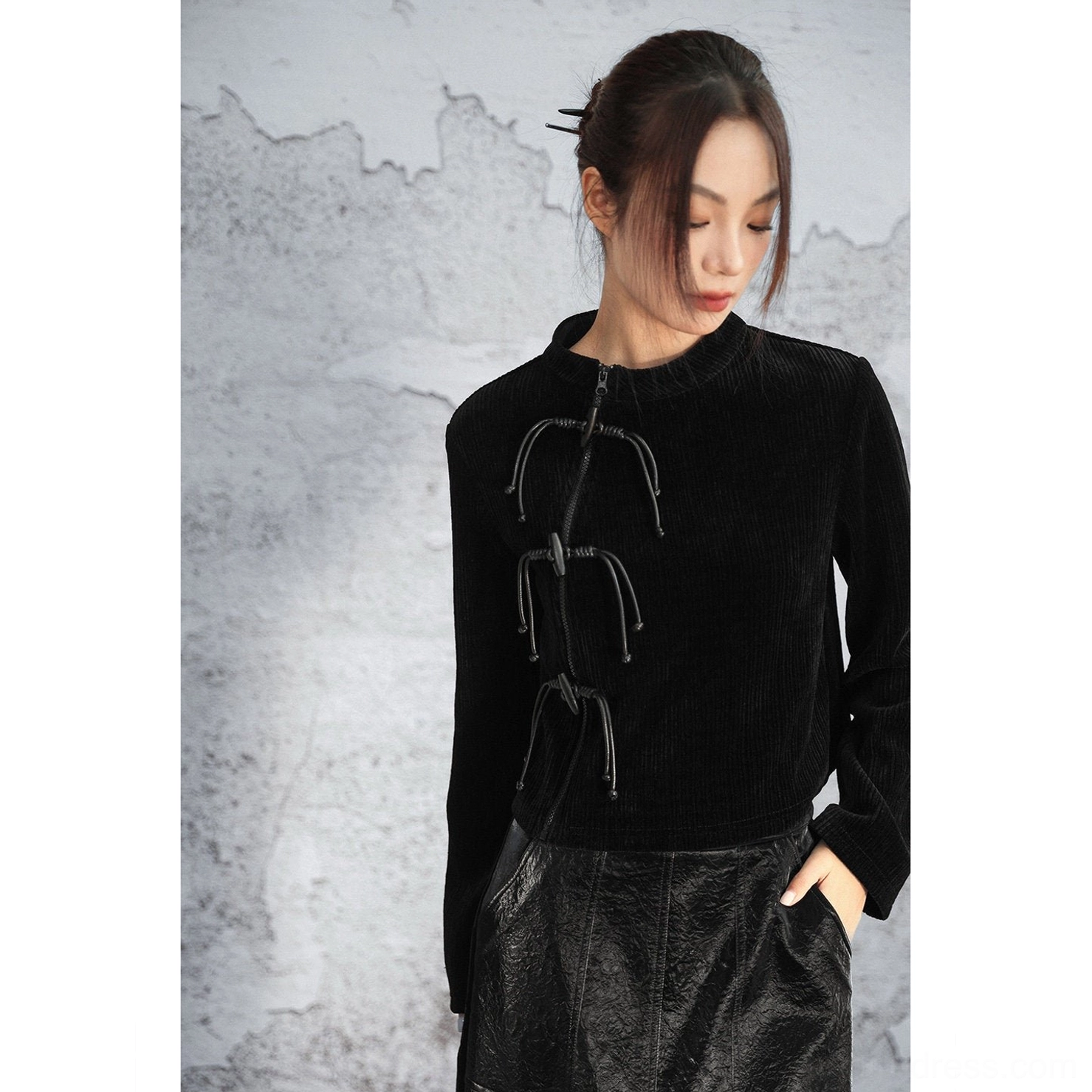 Close-up front view of a black modern Hanfu chenille sweater highlighting the raised vertical knit texture stand collar and decorative Chinese frog-style front fasteners