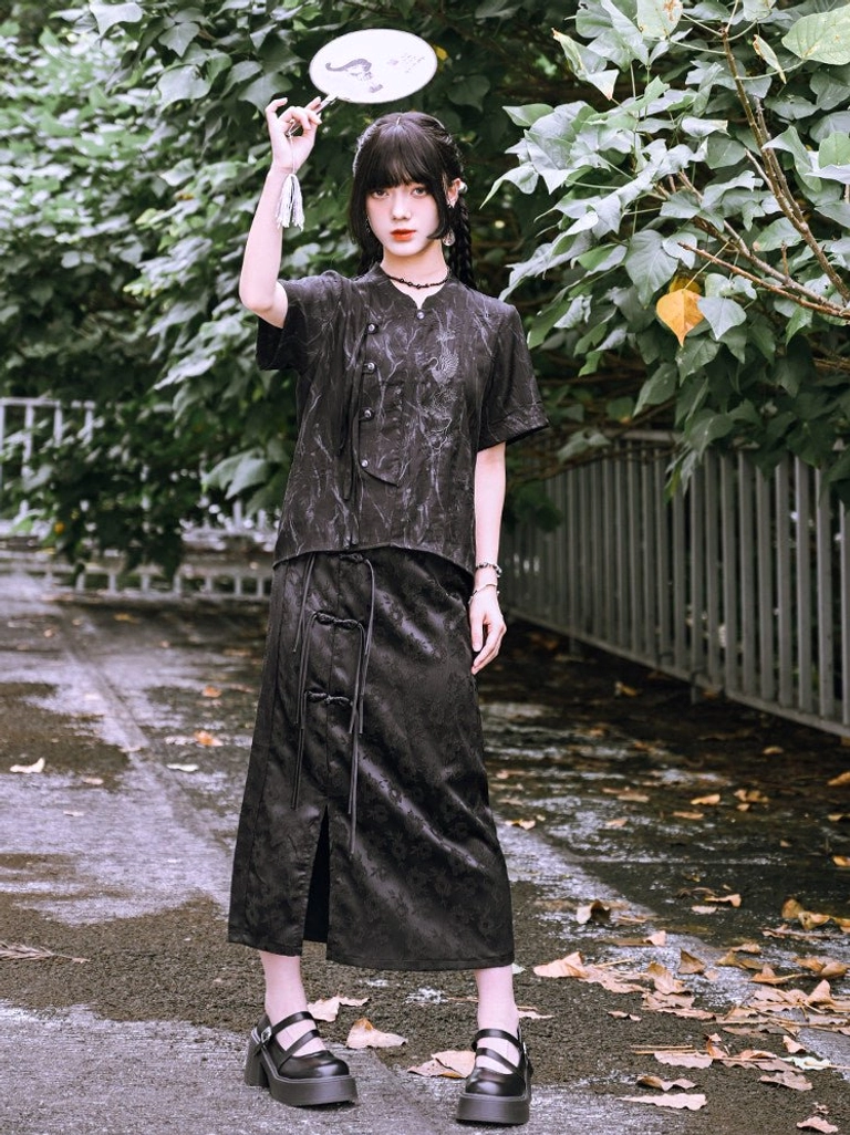 Full-body modern Hanfu outfit featuring black crane embroidered short sleeve shirt, matching slit midi skirt, round fan, and platform Mary Jane shoes