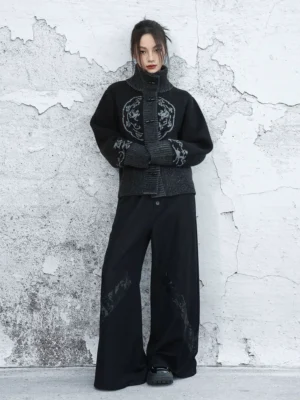 Full body front view of black New Chinese Style knit cardigan with stand collar and frog buttons paired with printed wide leg trousers