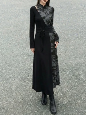 Front view of a black modern Hanfu long sleeve maxi dress with high stand collar, asymmetric shoulder cutout, two-tone patchwork, lace-up waist, and ankle boots