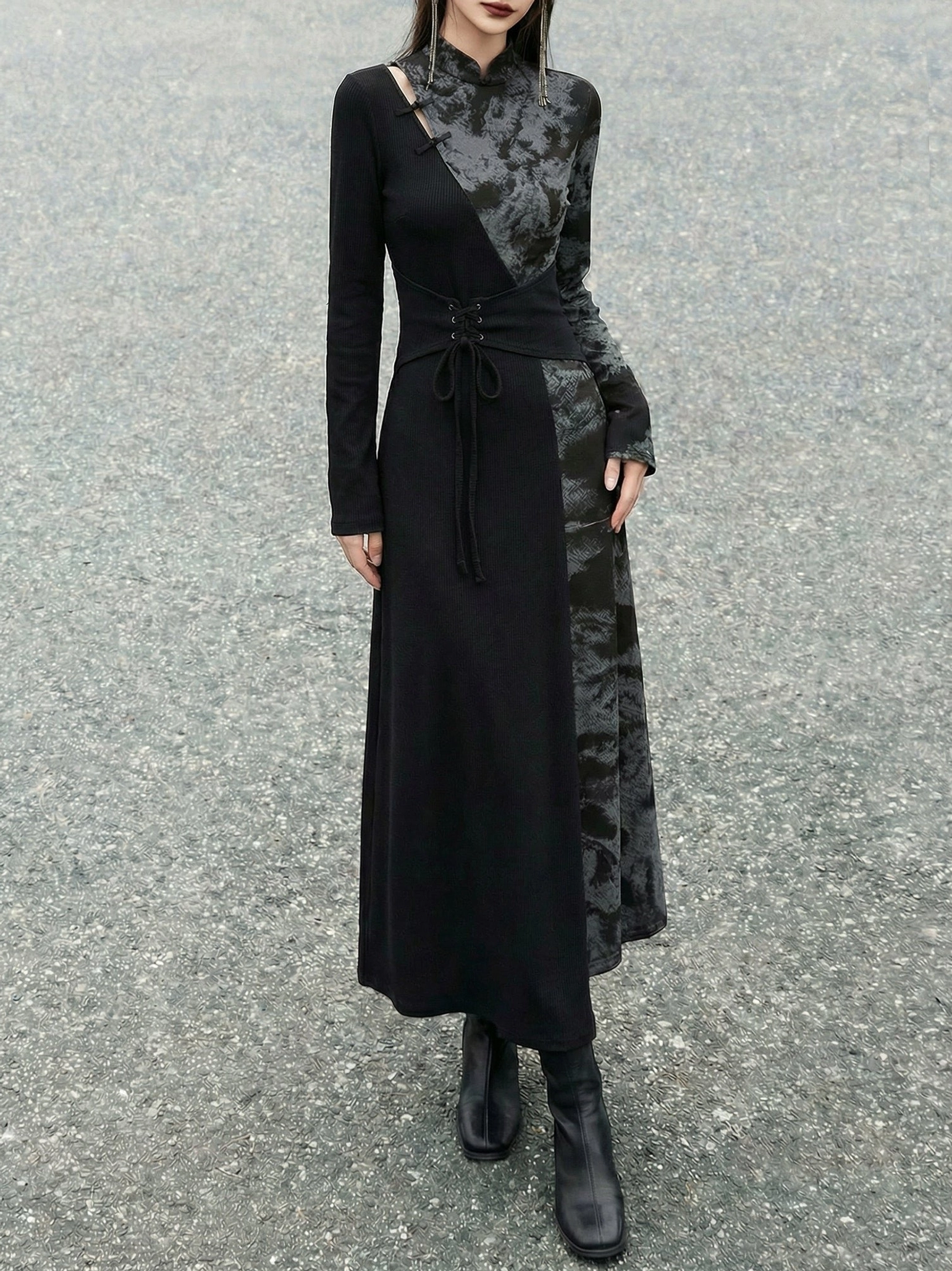 Front view of a black modern Hanfu long sleeve maxi dress with high stand collar, asymmetric shoulder cutout, two-tone patchwork, lace-up waist, and ankle boots