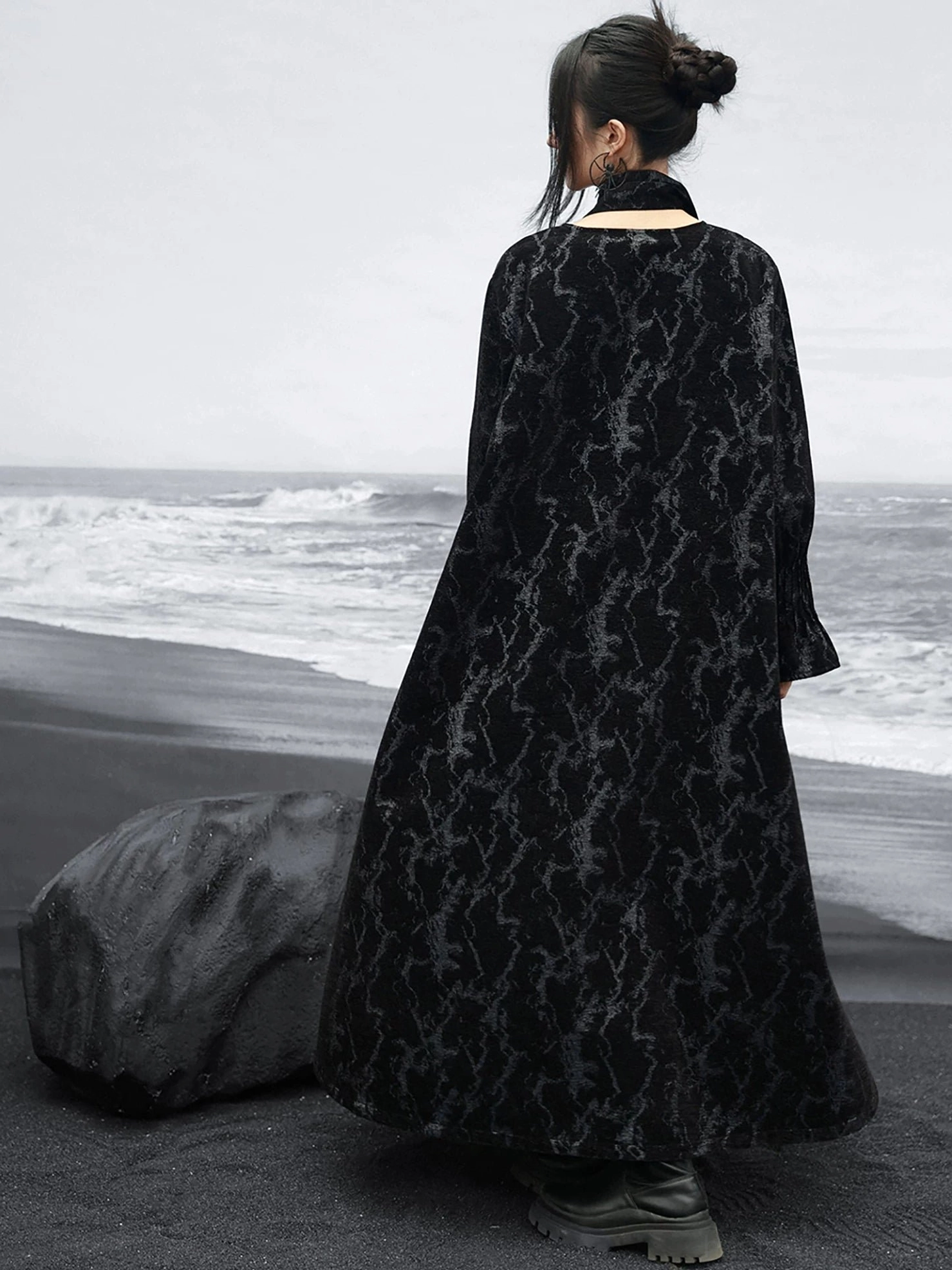 Back view of a black modern Hanfu loose maxi dress with halter neckline detail, open back accent, A-line silhouette, and flared cuffs