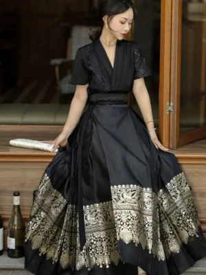 Black modern Hanfu mamianqun horse face skirt set with gold decorative hem, V-neck lace top, high waist, and flowing floor-length silhouette