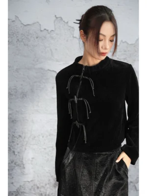 Front upper-body view of a black Chinese-inspired modern Hanfu sweater showing the soft vertical chenille knit texture and decorative frog-style fastener details