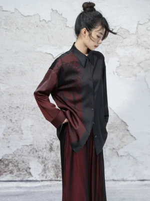 Left side full body view of a black and wine red chrysanthemum print satin modern Hanfu long sleeve top styled with matching wine red wide leg pants