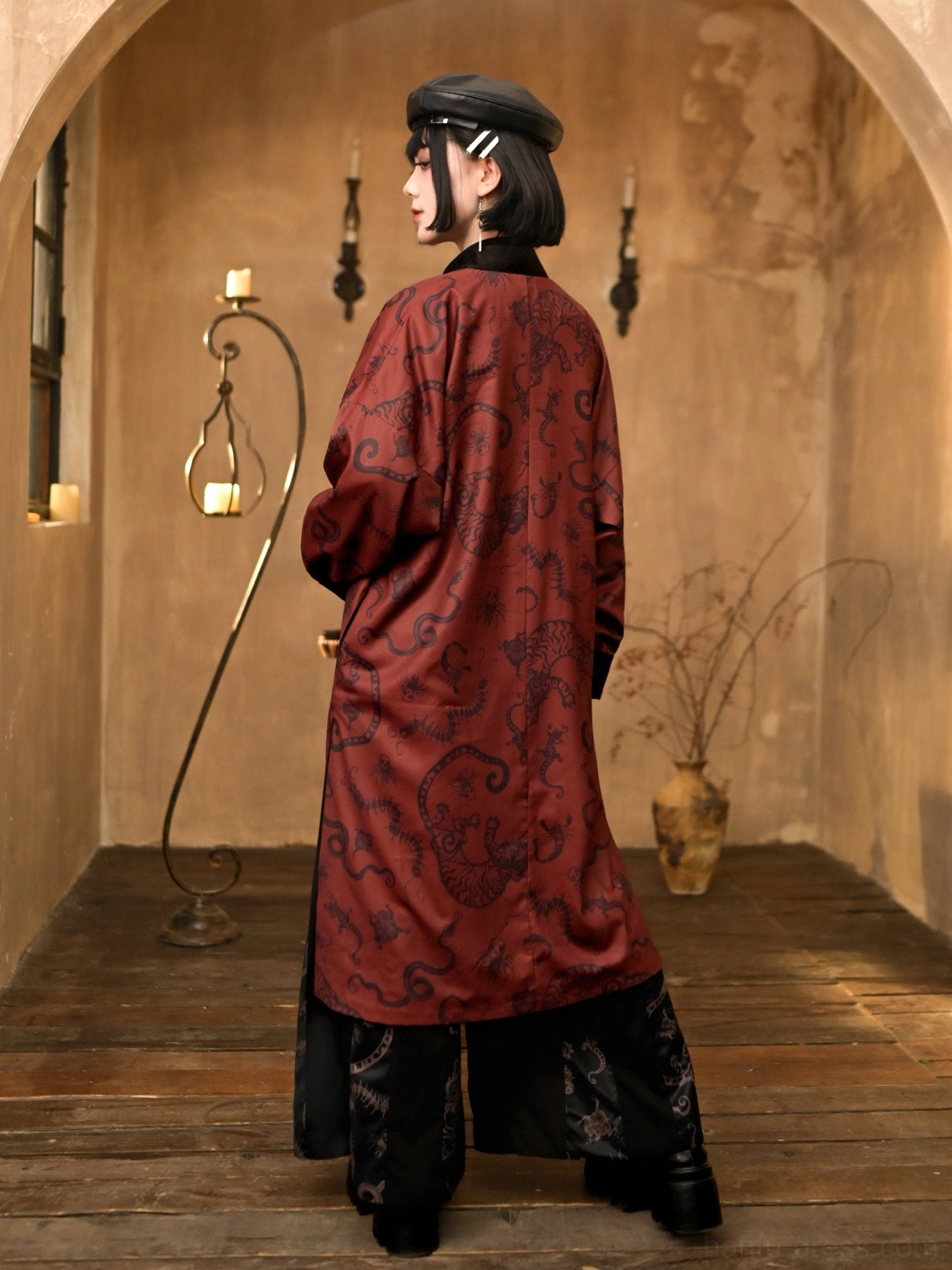 Back view of the flowing black and deep red modern Hanfu long coat displaying the full antique-inspired patterned back and extended coat length