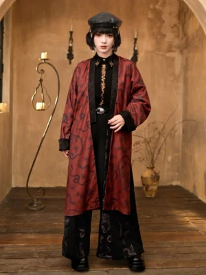 Full-body front view of a black and deep red Five Poisons modern Hanfu long coat with antique-inspired print, flowing silhouette, and decorative black trim in a vintage studio
