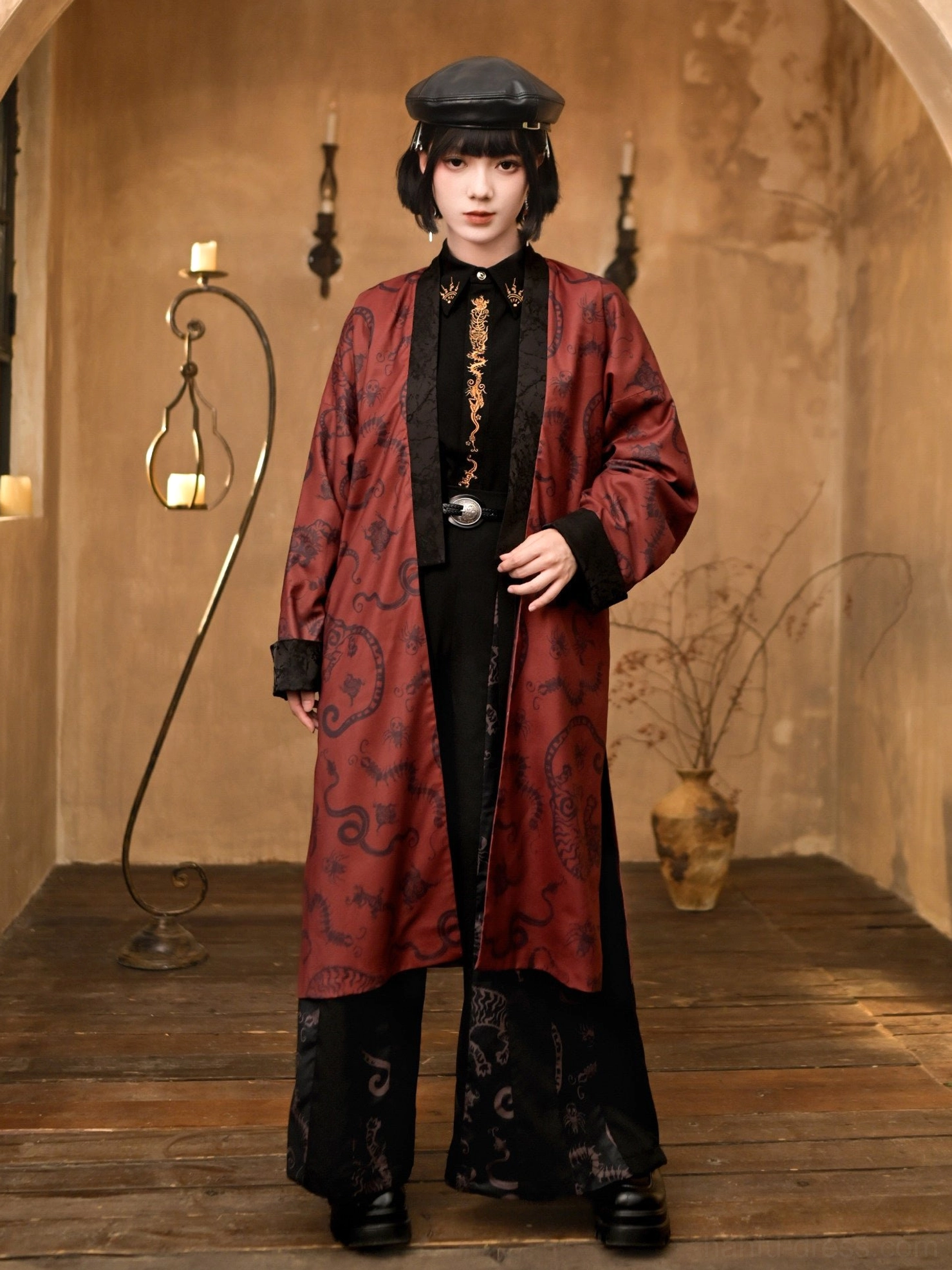 Full-body front view of a black and deep red Five Poisons modern Hanfu long coat with antique-inspired print, flowing silhouette, and decorative black trim in a vintage studio
