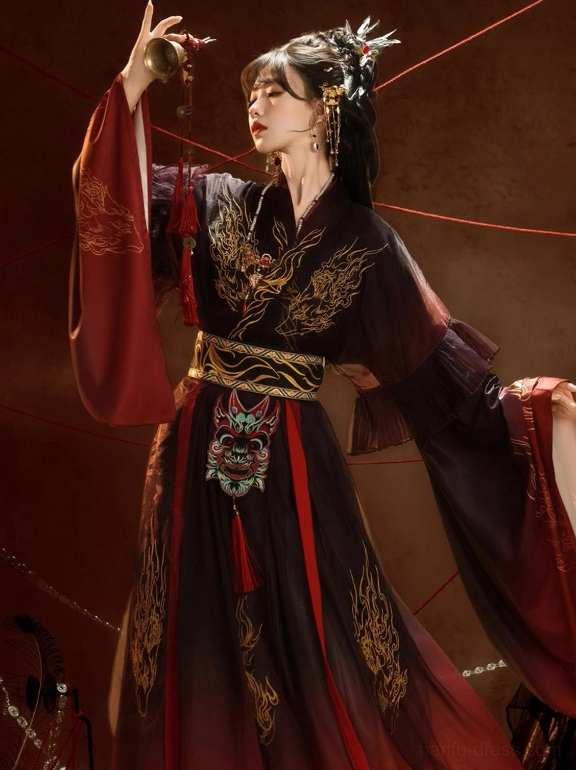 Close-up side view of black and red Nuo opera inspired Hanfu showing golden dragon chest embroidery, contrasting wide sleeves, red tassel waist pendant, and traditional styling