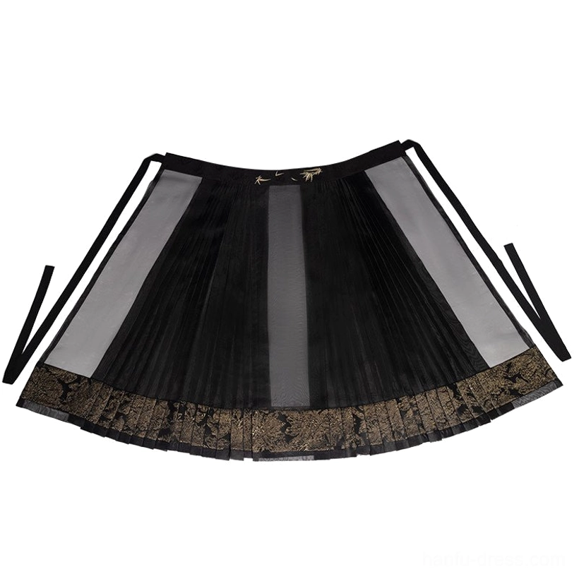 Black pleated mamian skirt with sheer side panels, gold toned floral lace hem, and embroidered waist ties