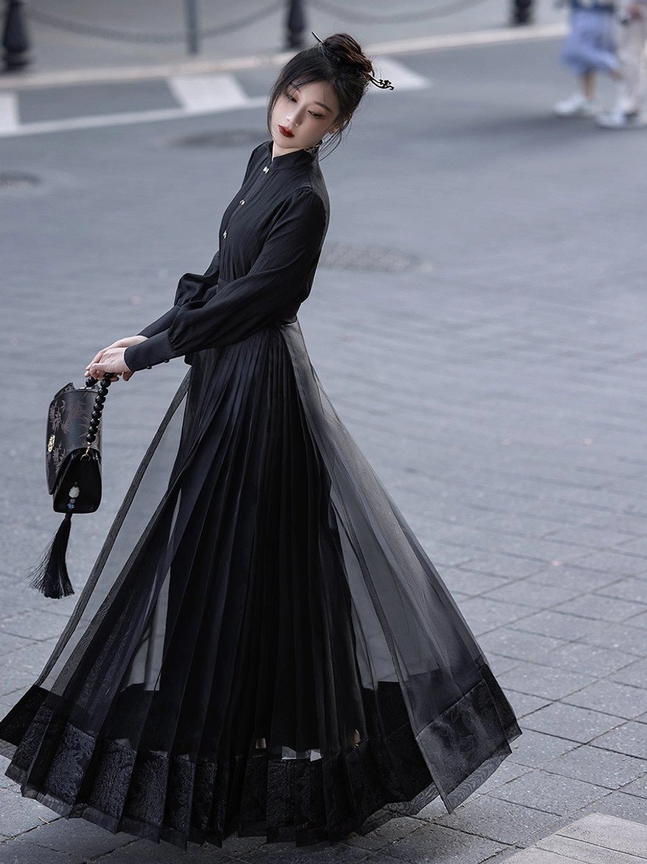 Black stand collar long sleeve Hanfu top with black sheer pleated mamian skirt in a modern city outfit