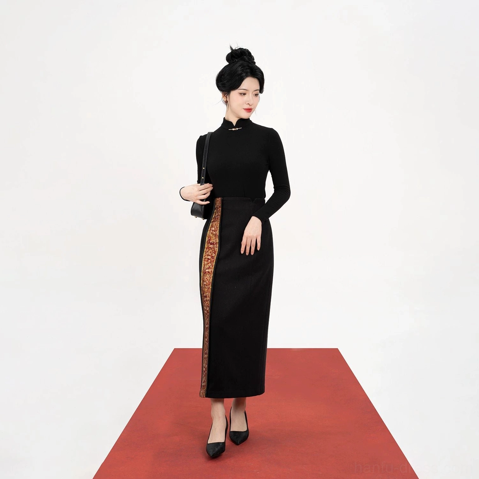 Flat lay front view of a minimalist black stand-collar long-sleeve Chinese-style top with traditional frog fastener