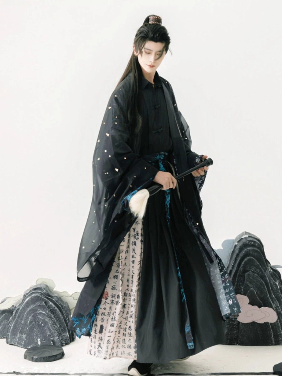 Side view of a black Taoist Hanfu outfit for men featuring a sheer dotted outer robe, printed skirt panels, wide sleeves, and layered traditional Chinese costume design