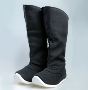 Black traditional Chinese Hanfu boots for men and women shown from a front left three-quarter angle, featuring an elegant upturned toe, tailored stitching, woven textile upper, and contrasting white rubber sole