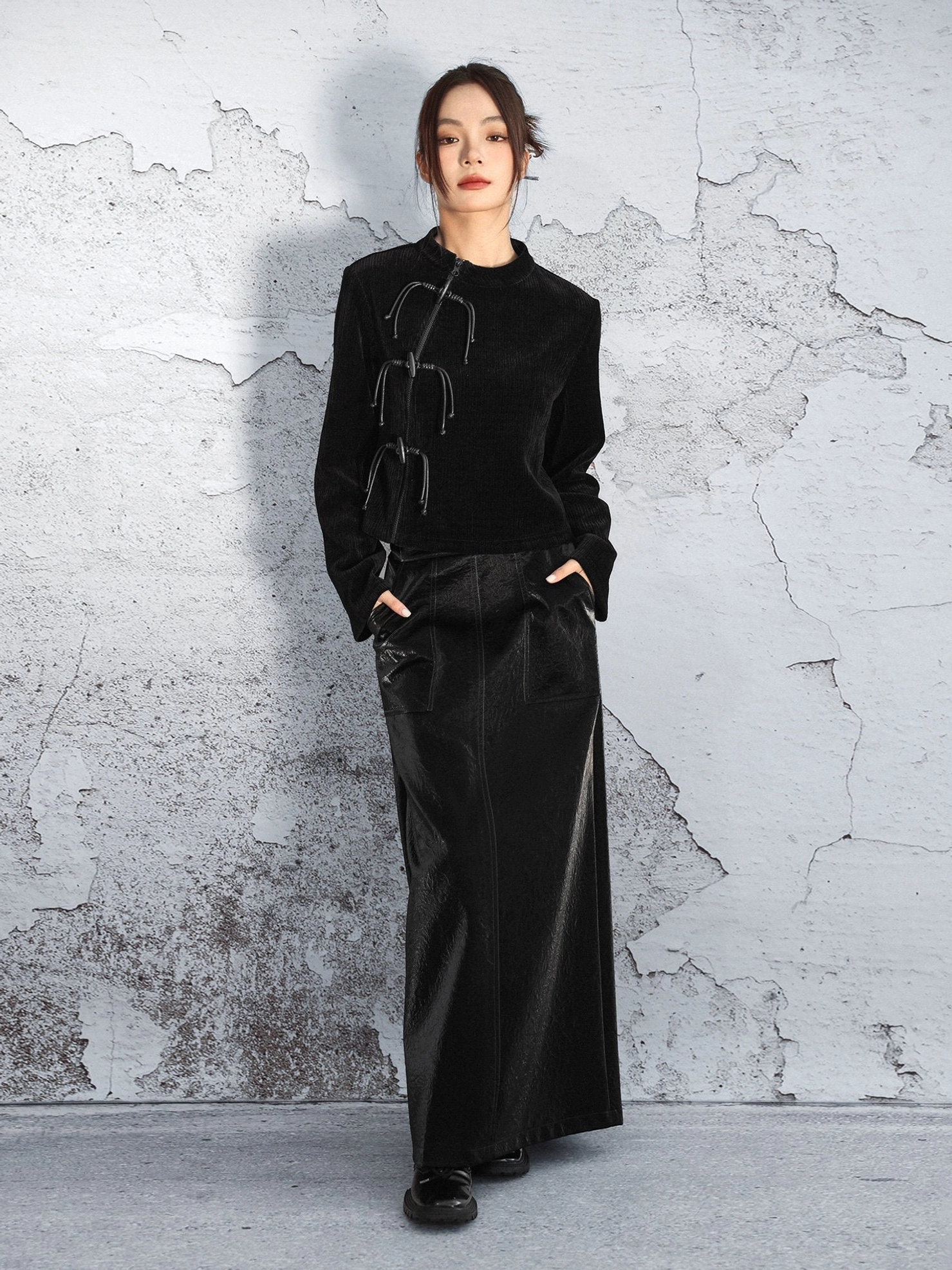 Full-body view of a black vertical stripe chenille modern Hanfu sweater styled with a long leather skirt for a contemporary Chinese-inspired outfit