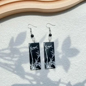 Black and white Chinese bamboo motif drop earrings with rectangular pendants, black beads, clear accent beads, and silver tone hooks for Hanfu jewelry