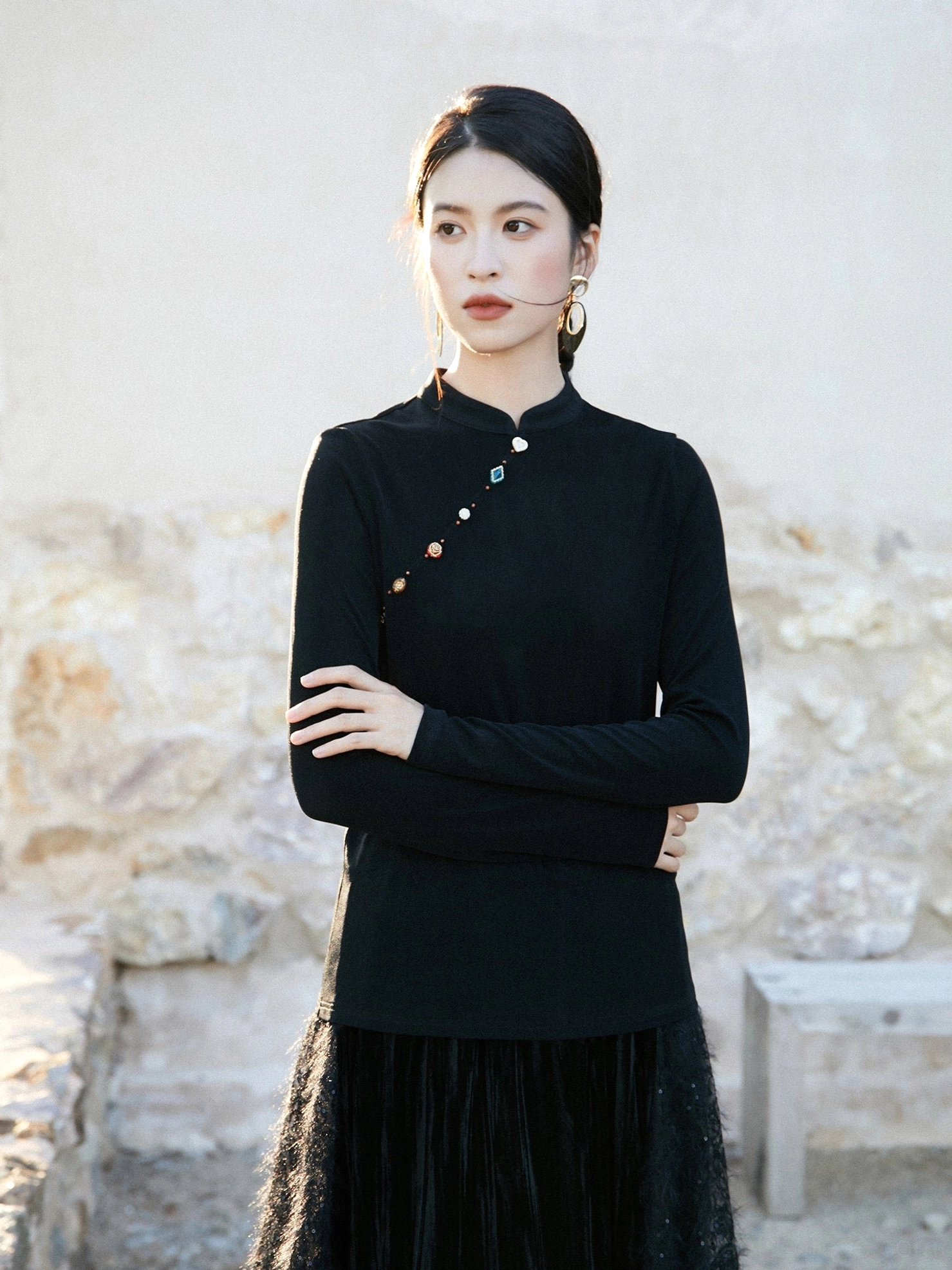 Black women’s satin shimmer modern Hanfu top with elegant stand collar, slanted decorative buttons, fitted long sleeves, and black tulle midi skirt