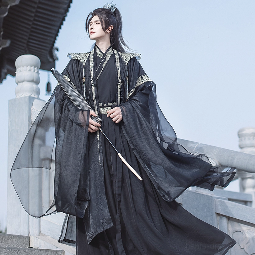 Black xianxia hanfu complete set for men with gold embroidery accents, dramatic sheer outer layers, and tassel folding fan