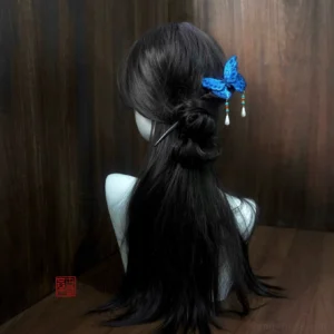 Back view of blue butterfly Chinese hair stick worn in a coiled bun hairstyle with cascading beaded tassels
