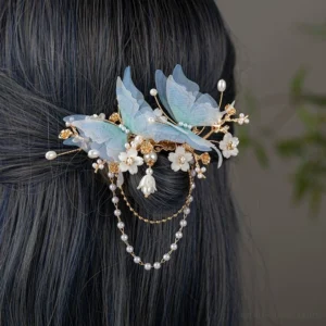 Light blue butterfly Hanfu back hair pin worn on dark hair with pearl chain tassels and lily pendants