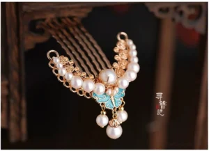 Blue butterfly pearl tassel Chinese hair comb pin with gold-tone metal filigree shown from a left oblique view for Hanfu and qipao hairstyles