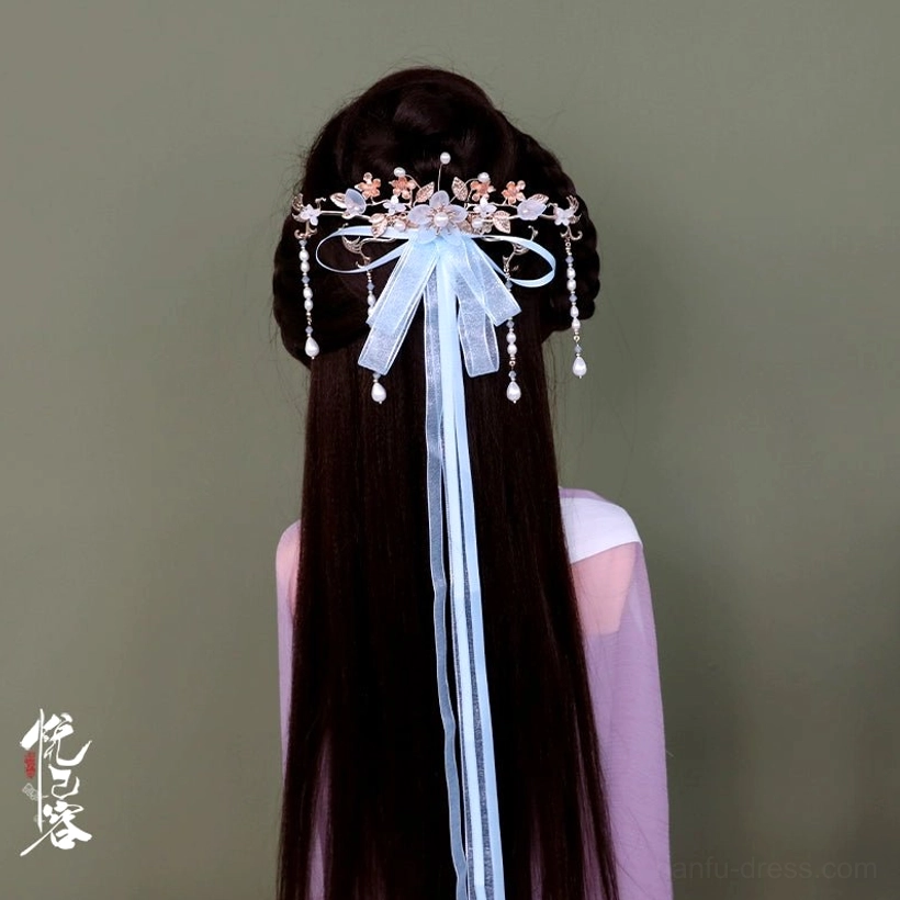 Blue Chinese hanfu back hair pin with light blue sheer ribbon, purple flowers, and crystal tassels styled on long hair