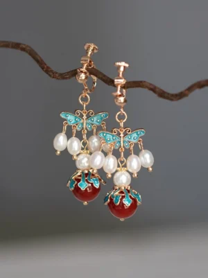 Comfort clip-on blue cloisonne butterfly Hanfu earrings with pearl bead accents and red agate pendants on branch