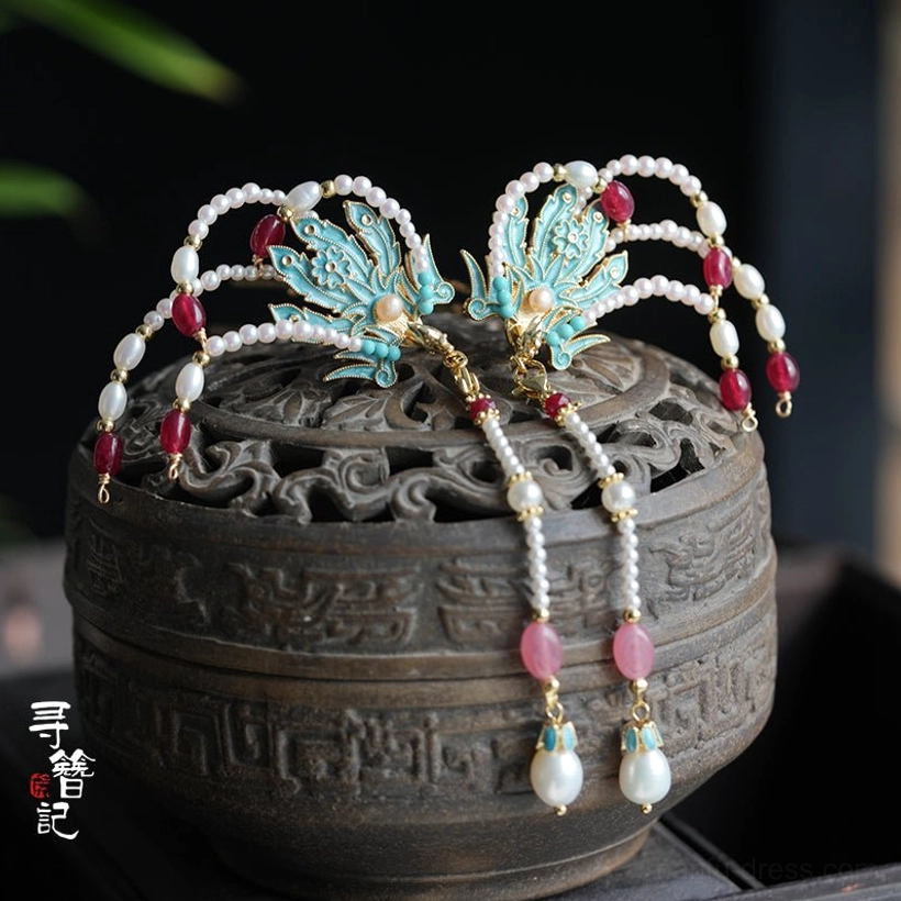 Blue cloisonne phoenix hanfu hairpins with pearl tassels displayed on a carved antique incense burner